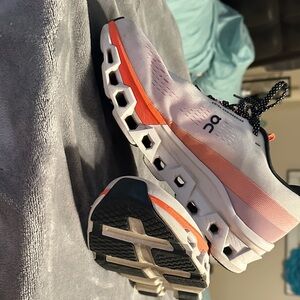 On Running White and Orange Athletic Shoes